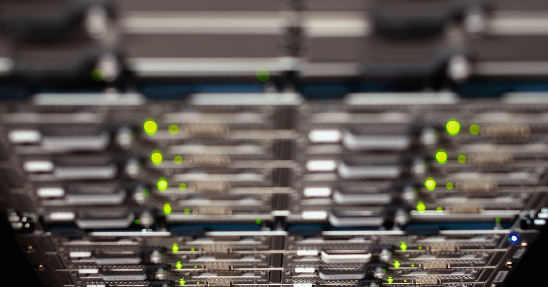 Racks of server drives in a data centre, status lights lit