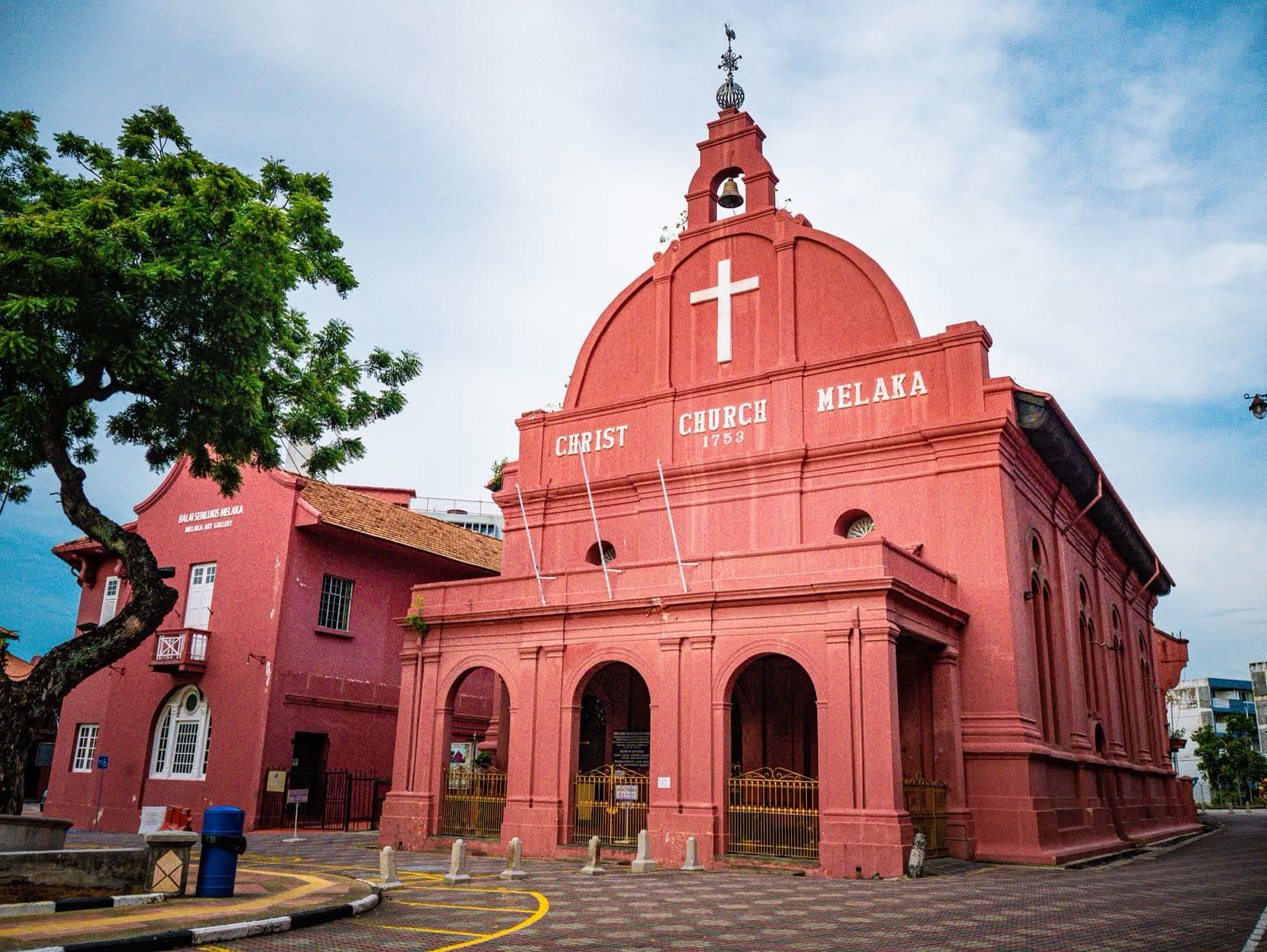 The red facade of Christ Church Melaka under a bright sky